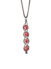 a necklace with red and white glass beads on it