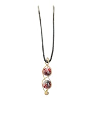 a necklace with three red glass beads on a black cord